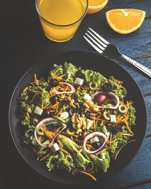 Turkey with kelp and leafy greens on a dark plate